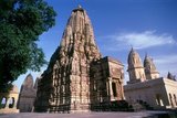 During the 10th and 11th centuries CE the Chandella Kings of central India, scions of a powerful Rajput clan who claimed the moon as their direct ancestor, built a total of 85 temples to the glory of God, the creation, and the Hindu pantheon. The Chandellas were devout Hindus.<br/><br/>

Eclipsed by the Mughal conquest, the rise of rival dynasties, and the passage of time, the temples languished in the harsh sun and monsoon rains of central India, gradually becoming lost in the jungle. At the time of their re-discovery in 1839, they were so completely overgrown that T. S. Burt, their founder, thought no more than seven temples had survived. Happily this proved far from the case, for when the undergrowth was hacked back and the complex restored, no fewer than twenty two of the original structures were revealed standing.