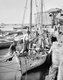 Palestine: A coastal boat being loaded with oranges by Palestinian men at Jaffa, c. 1910